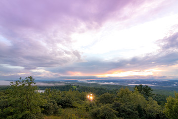Fog lifts from the Kittany Mountains at sunset at High Point State Park, the top of NJ, in mid summer