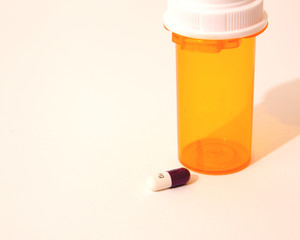 1 capsule and a pill bottle