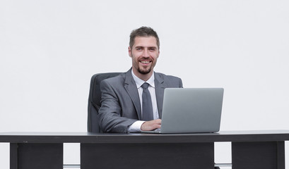 closeup.happy businessman working on laptop, sitting at desk