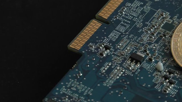 Three gold coins on the motherboard of the graphics chip.Cryptocurrencies.BTC golden coin as symbol of electronic virtual money for web banking and international network payment. 4K High gain effect.