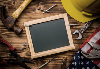 Happy Labor day. Construction tools. Copy space for text on wood background.