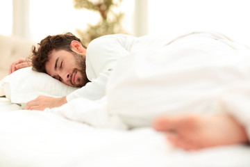 closeup.the tired men sleep soundly on the bed