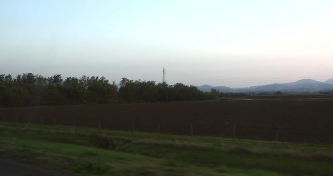 Pov driving view, through the countryside, towards napoli and pompei on Italian highway, road e45, on a sunny autumn evening sunset, in Italy