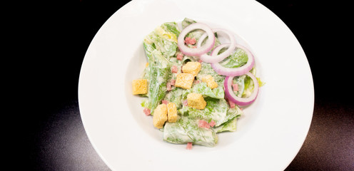 saesar slad on white dish