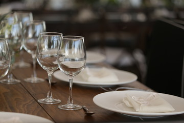 elegant Table decoration with wine glasses, glasses, forks, ornaments, ready to serve in event, wedding, celebration, xv years, baptism