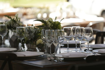 elegant Table decoration with wine glasses, glasses, forks, ornaments, ready to serve in event, wedding, celebration, xv years, baptism