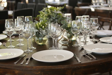 elegant Table decoration with wine glasses, glasses, forks, ornaments, ready to serve in event, wedding, celebration, xv years, baptism