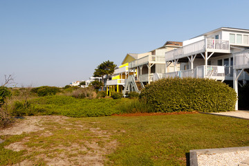 Fototapeta na wymiar Vacation beach rentals on the green sand dunes, Sunset Beach, North Carolina 