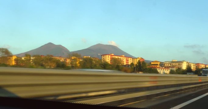 Pov view driving, through napoli and pompei on Italian highway e45, on a sunny autumn evening, in Italy
