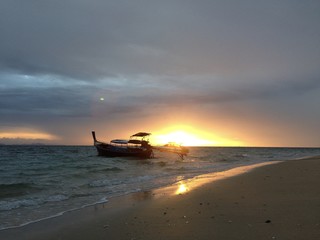 fishing boat on the beach under the beautiful sky