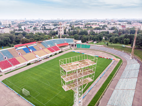 city sports stadium. football field and grandstands with colorful seats. aerial view