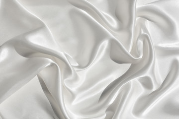 Fototapeta premium The texture of the satin fabric of white color for the background 