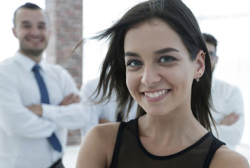 young employee of the company, standing in front of their colleagues.