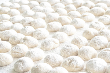 Fototapeta na wymiar Selective focus of dough balls on white wooden board