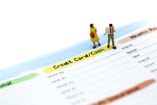 Miniature people : couple people standing with list of Credit Card,concept for Business,tax,money