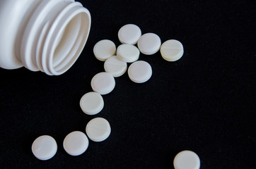 tablets are scattered on the table, dosage for the patient