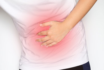 Man suffering from abdominal pain on white background.