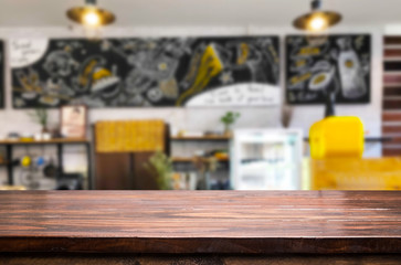 Selected focus empty brown wooden table and Coffee shop or restaurant blur background with bokeh image. for your photomontage or product display