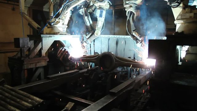 Automation welding mechanical procedure.,Industrial Robot arm active in factory