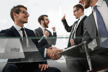 bottom view.businessmen shaking hands at the negotiating table