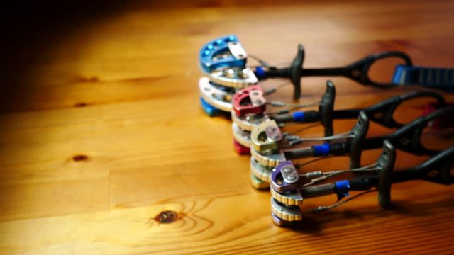 Various climbing cams on a wood table