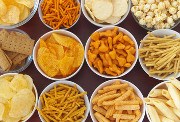 Crackers, chips, sticks, cookies, fast food background