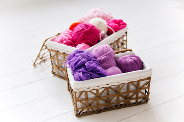 Fototapeta na wymiar top view of colored yarn balls and knitting needles