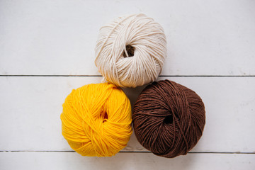 top view of colored yarn balls and knitting needles