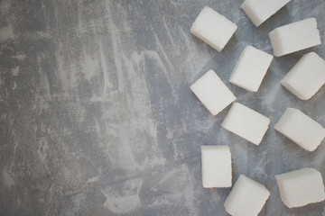sugar cubes on concrete background. Top view of white sugar . Sugar with copy space. Top view or flat lay