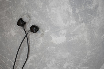 Black headset on a concrete background