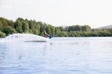 Young man riding wakeboard on a lake