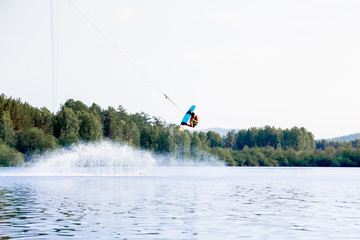 Young man riding wakeboard on a lake