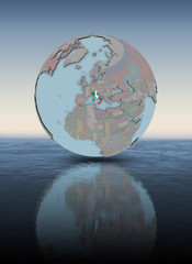 Italy on globe above water surface