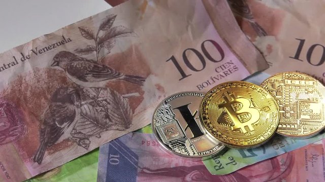 Physical metal Bitcoin currency over bolivar bills. Virtual internet money with Venezuelan banknotes. Digital coin cyberspace, cryptocurrency. BTC golden coin as symbol of electronic virtual money. 4K