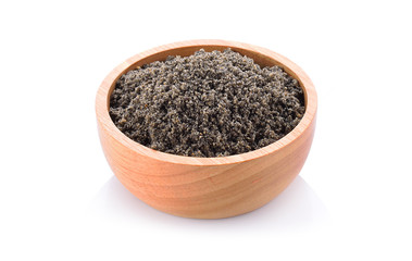 Crushed black sesame seeds on a white background.