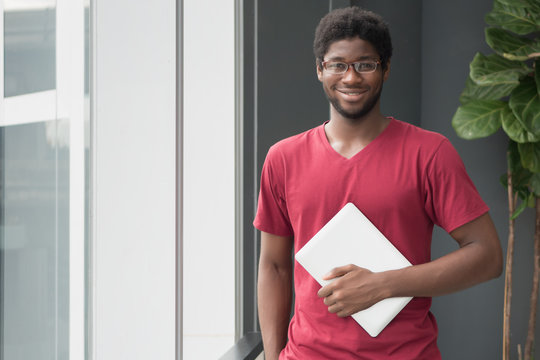 Happy College Student Gets Back To School; Portrait Of Happy Smiling Nerd Man, African College Student With Laptop Computer In University Campus, Back To School Concept; African Young Adult Man Model