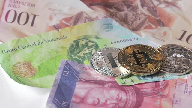 Physical metal Bitcoin currency over bolivar bills. Virtual internet money with Venezuelan banknotes. Digital coin cyberspace, cryptocurrency. BTC golden coin as symbol of electronic virtual money. 4K