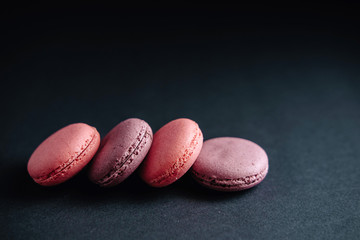 pink macarones on dark background