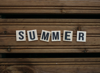 Summer. Text on a wooden background