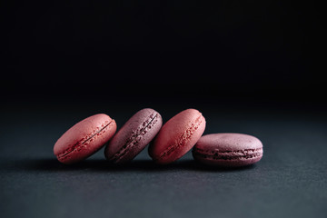 pink macarones on dark background