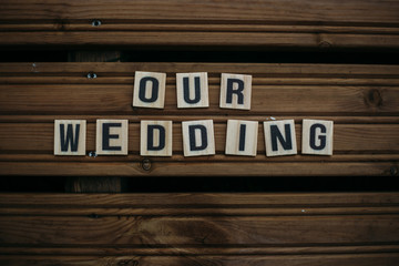 Our wedding. Text on a wooden background