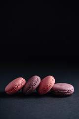 pink macarones on dark background