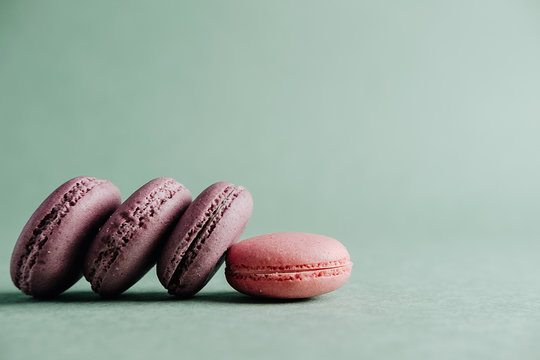 pink macarones on green background