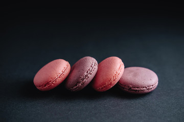 pink macarones on dark background