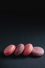 Obraz na płótnie Canvas pink macarones on dark background
