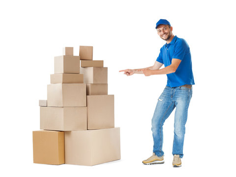 Delivery man pointing to stack of boxes isolated on white background