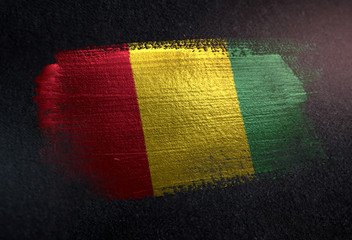 Guinea Flag Made of Metallic Brush Paint on Grunge Dark Wall