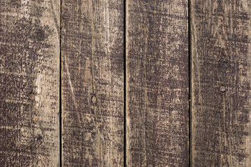 Close up of old washed out weathered stripped brown wooden planks with scratches and nails. Abstract natural texture background