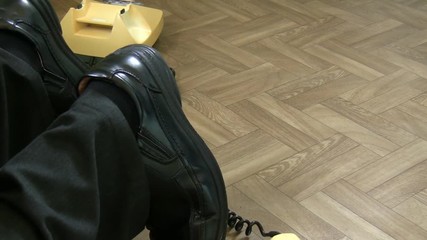 Accident, health and safety hazard concept. Legs of man tripping over hanging old rotary telephone cable or wire in the office or room