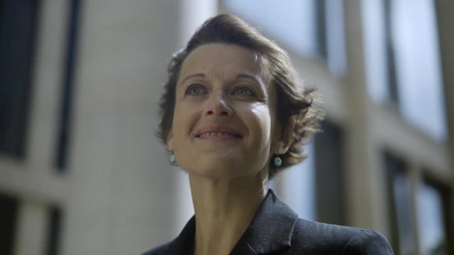 Close-up of romantic middle adult woman looking away and waiting for somebody to come on windy day